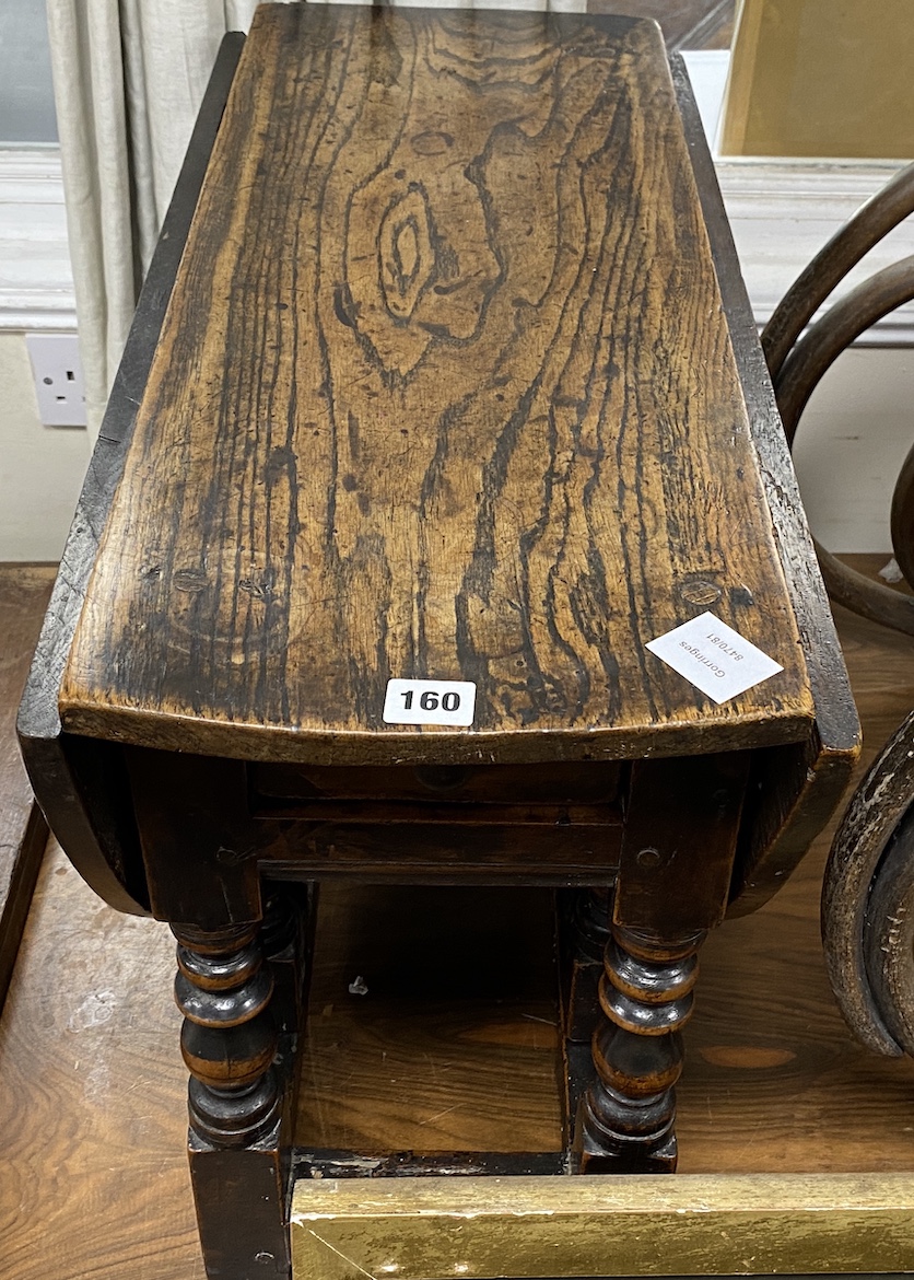 A Charles II low oak and fruitwood oval gateleg table (made-up), with a drawer, square and bobbin turned legs joined by stretchers, width 70cm, depth 30cm, height 49cm